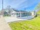 Exterior view of home with light blue siding, a newly poured concrete driveway, and a well-manicured lawn at 1017 Martin Luther King Jr Dr, Atlanta, GA 30314