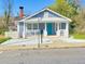 Charming single-story home with light blue siding, a quaint front porch, and a well-manicured lawn at 1017 Martin Luther King Jr Dr, Atlanta, GA 30314