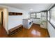 Laundry room featuring full sized washer and dryer, wood floors, shelving and plenty of natural light at 1017 Martin Luther King Jr Dr, Atlanta, GA 30314