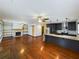 Open-concept living area featuring a fireplace, exposed shelving, hardwood floors, and a kitchen island at 1017 Martin Luther King Jr Dr, Atlanta, GA 30314