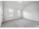 Neutral bedroom features two sunny windows, plush carpeting, and light gray walls at 2098 Bridgewater Pass, Hampton, GA 30228