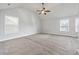 Spacious bedroom with vaulted ceiling, ceiling fan, large carpet and multiple windows at 2098 Bridgewater Pass, Hampton, GA 30228