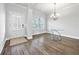 Dining area with modern chandelier, wood floors, bright window and neutral color palette at 2098 Bridgewater Pass, Hampton, GA 30228