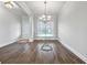 Dining area featuring wood floors, neutral gray walls and a decorative chandelier fixture at 2098 Bridgewater Pass, Hampton, GA 30228