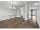 Bright dining room area featuring wood flooring, chandelier lighting, and neutral wall color at 2098 Bridgewater Pass, Hampton, GA 30228