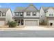 Two-story home featuring brick facade, two-car garage and well-maintained landscaping at 2098 Bridgewater Pass, Hampton, GA 30228