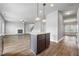 Open kitchen view showing island with seating, stainless appliances and hardwood flooring at 2098 Bridgewater Pass, Hampton, GA 30228