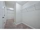 Spacious walk-in closet featuring carpet flooring and wire shelving for organizing clothes at 2098 Bridgewater Pass, Hampton, GA 30228