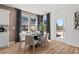 Dining area with modern table and chairs with decoratively patterned curtains and a view of the neighborhood at 313 Heavenly Hollow Pl, Mcdonough, GA 30253