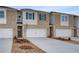 Beautiful townhome with brick facade, a two-car garage, and newly planted landscaping at 313 Heavenly Hollow Pl, Mcdonough, GA 30253