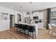 Kitchen featuring a modern island with seating, stainless steel appliances, and contemporary lighting at 313 Heavenly Hollow Pl, Mcdonough, GA 30253