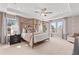 Bright main bedroom featuring a decorative ceiling, large windows, and a four poster bed at 313 Heavenly Hollow Pl, Mcdonough, GA 30253