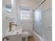 Bright bathroom features white tile, a modern gold faucet, a vessel sink, and a tub shower at 4624 College St, Forest Park, GA 30297