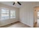 Cozy bedroom with a ceiling fan, wood-look floors, and views into the hall at 4624 College St, Forest Park, GA 30297