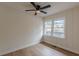 Charming bedroom featuring wood-look flooring, a ceiling fan, and double windows offering natural light at 4624 College St, Forest Park, GA 30297