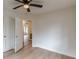 Neutral bedroom with wood-look floors, ceiling fan, and a convenient closet with easy hall access at 4624 College St, Forest Park, GA 30297