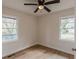 Comfortable bedroom featuring dual windows, wood-look flooring, and a ceiling fan at 4624 College St, Forest Park, GA 30297