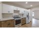 Well-appointed kitchen with two-tone cabinetry, modern appliances, and ample counter space at 4624 College St, Forest Park, GA 30297