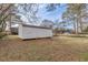 View of the home's backyard shed and the surrounding green lawn at 4624 College St, Forest Park, GA 30297