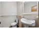 Bathroom featuring a pedestal sink, wainscotting, and tile flooring at 507 Ridge View Xing, Woodstock, GA 30188