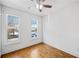 Bright bedroom featuring hardwood floors, a ceiling fan, and two large windows at 507 Ridge View Xing, Woodstock, GA 30188