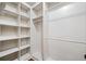 Walk-in closet with built-in shelving and hanging rods for organized storage at 507 Ridge View Xing, Woodstock, GA 30188