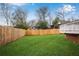 Fenced backyard with a lush green lawn, providing privacy and a great space for activities at 731 Mollie Se St, Atlanta, GA 30316