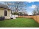 Spacious backyard with lush grass, a tall fence, and an outdoor deck at 731 Mollie Se St, Atlanta, GA 30316