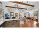 Open-concept living room with vaulted ceiling, exposed wood beams, and hardwood floors at 731 Mollie Se St, Atlanta, GA 30316