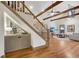 Open-concept living space with hardwood floors, exposed beams, and a staircase at 731 Mollie Se St, Atlanta, GA 30316