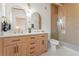 Bathroom featuring a wood grain double vanity, arch mirrors, and large glass enclosed shower at 2111 Drew Valley Ne Rd, Brookhaven, GA 30319