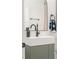 Bathroom sink featuring dark fixtures, green vanity with gold knobs, and a stylish framed mirror at 2111 Drew Valley Ne Rd, Brookhaven, GA 30319
