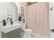 Bathroom featuring a sink with black hardware, a toilet and a tan curtain with a grid pattern at 2111 Drew Valley Ne Rd, Brookhaven, GA 30319