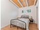 Charming bedroom features light wood floors, white walls and a wood planked ceiling with exposed beams at 2111 Drew Valley Ne Rd, Brookhaven, GA 30319