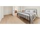 This stylish bedroom features an iron bed, light wood floors and french doors to a living space at 2111 Drew Valley Ne Rd, Brookhaven, GA 30319