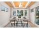 Bright dining area with wood ceiling beams, modern table, and large windows at 2111 Drew Valley Ne Rd, Brookhaven, GA 30319