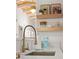 Modern kitchen features a gold faucet, white countertops, and open shelving at 2111 Drew Valley Ne Rd, Brookhaven, GA 30319