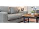 This well-lit living room shows a comfortable gray sofa and view to a bedroom through french doors at 2111 Drew Valley Ne Rd, Brookhaven, GA 30319