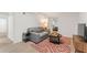 Cozy living room featuring a comfortable gray sofa, patterned rug, and a television, perfect for relaxation at 2111 Drew Valley Ne Rd, Brookhaven, GA 30319