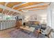 Cozy living room with wood ceiling beams, stylish furniture, and decorative rug at 2111 Drew Valley Ne Rd, Brookhaven, GA 30319