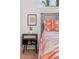 Close up of a nightstand with a wood design, picture and bed with an orange patterned blanket at 2111 Drew Valley Ne Rd, Brookhaven, GA 30319