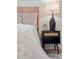 Bedroom nightstand featuring a lamp, a clock, gold accents and stylish design at 2111 Drew Valley Ne Rd, Brookhaven, GA 30319