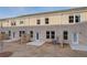 Rear exterior view featuring a brick building, patios, and lawn at 321 Heavenly Hollow Pl, Mcdonough, GA 30253