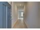 Bright hallway features wood floors, neutral walls, and natural light from the window ahead at 321 Heavenly Hollow Pl, Mcdonough, GA 30253