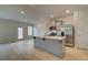 Spacious kitchen island with stainless sink, lots of light, open to living room, wood floors at 321 Heavenly Hollow Pl, Mcdonough, GA 30253