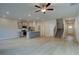 Open concept living area with lots of light, wood floors, stairs, and stainless appliances at 321 Heavenly Hollow Pl, Mcdonough, GA 30253