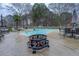 Backyard pool with patio, outdoor fire pit, and chairs at 3496 Honeycomb Dr, Conyers, GA 30094