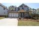 New construction home with a brick and siding exterior, attached garage, and landscaping at 4445 Beechnut Cir, Cumming, GA 30028