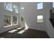 Bright living room with large windows providing natural light and dark hardwood floors at 4445 Beechnut Cir, Cumming, GA 30028