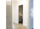 Hallway view of bathroom with wood flooring, gray vanity, and gray door at 5252 Biffle Rd, Stone Mountain, GA 30088